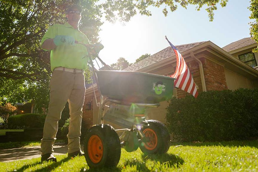 contact-title Man pushing a seeding cart.