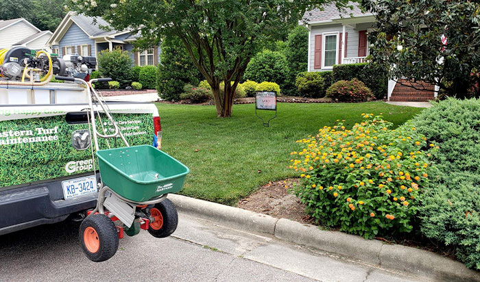raleigh-title E.T.M. truck in front of manicured lawn.